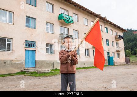 Kirgisistan, Dorf Djety-Oguz, Kind, das die kirgisische Flagge schwenkt Stockfoto