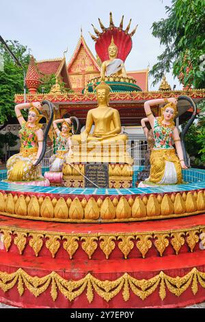 Ein Brunnen im Freien, voller goldener Figuren und eines sitzenden Buddha. Im Wat That Luang Tai in Vientiane, Laos. Stockfoto