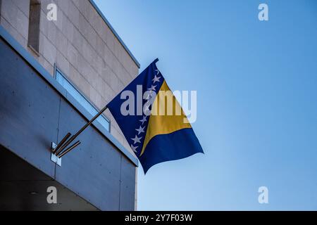 Bosnische Flagge in Sarajevo 21.09.24, Sarajevo: Symbolfoto, Illustrationsbild, Symbolbild, Illustrationsfoto, Alltagsszene Bosnische Flagge in Sarajevo die Flagge von Bosnien und Herzegowina weht an einem Gebäude in Sarajevo gegen einen klaren, blauen Himmel. Die gelben und blauen Farben sowie die weißen Sterne stehen im starken Kontrast zu der modernen Architektur im Hintergrund. Sarajevo Bosnien-Herzegowina *** bosnische Flagge in Sarajevo 21 09 24, Sarajevo Symbolfoto, Illustrationsfoto, Symbolfoto, die bosnische Flagge in Sarajevo die Flagge von Bosnien und Herze Stockfoto