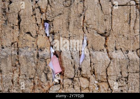 Winzige Zettel mit geschriebenen Gebeten zu Gott werden in die Risse der Westmauer in Jerusalem, Israel, eingefügt. Stockfoto