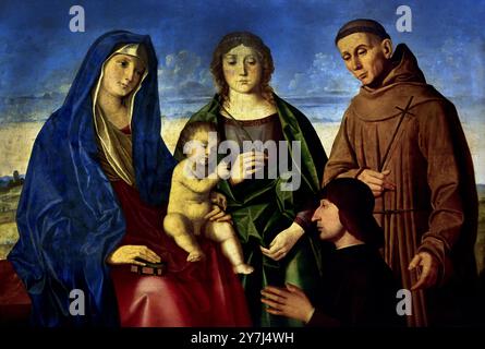 Madonna und Kind mit einem heiligen Märtyrer, Hl. Franz von Assisi und der Spender 1508–1510 von Vincenzo Catena 1480–1531, 16. Jahrhundert, Italien, Italienisch. (Maler der venezianischen Renaissance-Schule. Er ist auch als Vincenzo de Biagio bekannt. Stockfoto