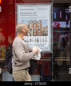 London, England, Großbritannien. 30. September 2024. Man sieht Menschen, die an einer Immobilienagentur im Zentrum Londons vorbeilaufen. Die britischen Häuserpreise steigen mit ihrem höchsten Jahreszins seit fast zwei Jahren, da die Kreditkosten weiterhin sinken, nachdem die Erwartungen erfüllt wurden, dass die Bank of England die Zinssätze weiter senken wird, teilte Â Nationwide Building societyÂ mit. Die Preise stiegen im September gegenüber dem Vorjahresmonat um 3,2 % und damit deutlich über dem Jahreswachstum von 2,4 % im August und dem schnellsten Tempo seit den 4,4 % im November 2022. (Kreditbild: © Tayfun Salci/ZUMA Press Wire) REDAKTIONELLE VERWENDUNG Stockfoto