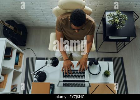 Draufsicht eines jungen Mannes mit gemischter Rasse, der im Büro arbeitet Stockfoto