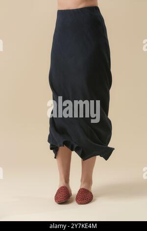 Serie von Studiofotos eines jungen weiblichen Models in Einem geformten Midirock aus Leinen. Lässiges und stilvolles Outfit, Basic Fashion-Artikel, Frühling/Sommer-Trend. Stockfoto