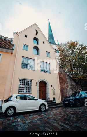 Blauer Turm der St. Olaf Kirche hinter dem alten Haus in der Altstadt in Tallinn, Estland Stockfoto