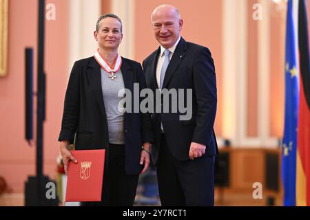 Berlin, Deutschland. Oktober 2024. Kai Wegner (CDU, r), Regierender Bürgermeister von Berlin, überreicht Uta Rinklebe, Direktorin der MACHmit! museum, im Roten Rathaus. Quelle: Sebastian Gollnow/dpa/Alamy Live News Stockfoto