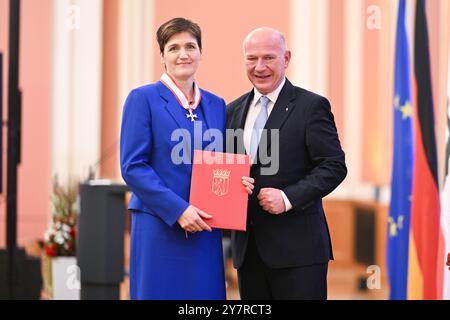 Berlin, Deutschland. Oktober 2024. Kai Wegner (CDU, r), Regierender Bürgermeister von Berlin, überreicht Katja Urbatsch, Geschäftsführerin der gemeinnützigen Organisation ArbeiterKind.de, im Roten Rathaus den Verdienstorden des Landes Berlin. Quelle: Sebastian Gollnow/dpa/Alamy Live News Stockfoto