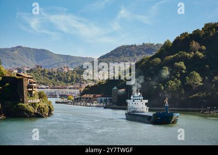 29-10-2024 Blick auf ein Frachtschiff, das den Hafen von Pasaia verlässt, von Pasai Donibane aus gesehen Stockfoto