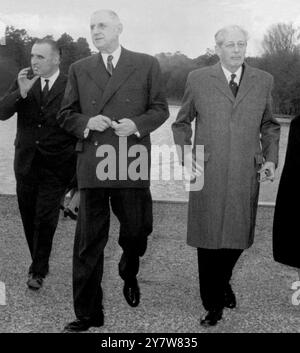 Mit Rambouillet Castle Park im Hintergrund macht der britische Premier Harold Macmillan (rechts) einen Sir Winston Churchill - spaziert mit VIP's und hält eine Zigarre in der linken Hand. Von links nach rechts sind der französische Premierminister Georges Pomidou, der französische Präsident General Charles de Gaulle und Harold Macmillan. Ebenfalls anwesend waren Madame de Gaulle und Madame Pompidou. Die Party ging nach dem Mittagessen hier spazieren. Herr Macmillan ist zu Gesprächen hier, und es wird erwartet, dass die meisten seiner Gespräche den Beitritt Großbritanniens zum Gemeinsamen Markt betreffen werden. 16. Dezember 1962 Stockfoto