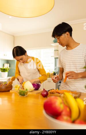 Gemüse zubereiten, junge asiatische Brüder und Schwestern kochen zusammen in der modernen Küche Stockfoto