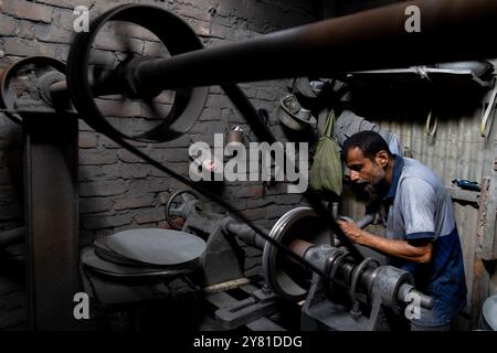 Dhaka, Dhaka, Bangladesch. Oktober 2024. In Kamrangirchar in Dhaka arbeiten Aluminiumfabriken unter gefährlichen Bedingungen. Arbeiter ohne Schutzausrüstung sind mit schädlichem Aluminiumstaub beschichtet, wenn sie schwere Maschinen in einer engen, schwach beleuchteten Umgebung handhaben. Wenn sie minimalem Licht von oben ausgesetzt sind, stehen sie neben gesundheitlichen Problemen vor schweren Sehstörungen. In Niedriglohnarbeitsplätzen gefangen, sehen sich diese Arbeiter fortwährend der Ausbeutung ausgesetzt, gefangen in einem Kreislauf von Armut und gefährlicher Arbeit, die ihr Wohlergehen gefährdet. (Kreditbild: © Joy Saha/ZUMA Press Wire) NUR REDAKTIONELLE VERWENDUNG! Nicht für Commerci Stockfoto