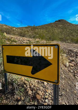 Ein Richtungsschild, das auf den Ausgang mit einem kleinen Berg zeigt Stockfoto