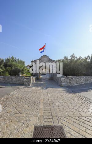 Skyline einer kleinen mediterranen Stadt, historisches Stadtzentrum mit massiven Stadtmauern auf einer Insel in einer Bucht oder Lagune. Morgenstimmung in Nin, Zadar Stockfoto