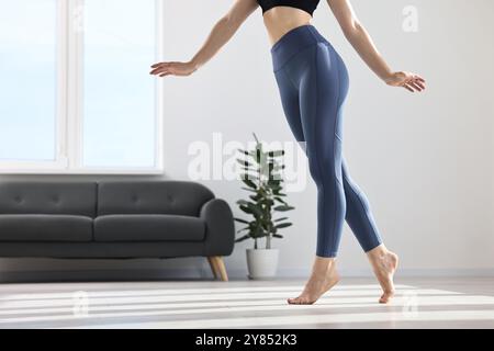 Frau trägt blaue Sportleggings im Zimmer, Nahaufnahme Stockfoto