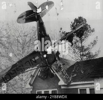 Flying Doctor macht Überraschung -- Privatflugzeug von Dr. J.T. Giles, fliegender Arzt von Griffin, Ga, liegt gestern auf dem Haus von Turner Quillian hier. Das Flugzeug hatte vor der Ankunft am Flughafen Probleme mit dem Motor und das Dach von Quillians Haus sah aus wie der beste Ort zum Landen. Dr. Giles wurde nicht schwer verletzt. Quillians Frau und zwei Kinder waren im Haus, aber sie waren unverletzt. Die Schäden am Dach wurden auf 1.000 US-Dollar geschätzt. Surprise Landing wurde von dem Flugarzt Dr. J.T. Giles in Georgia (USA) gemacht, als er am Heiligabend in Lagrange eintraf. Nach seinem Ent Stockfoto