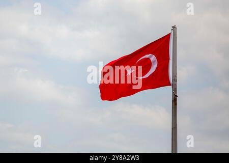 Antakya, Türkei. April 2023. Die türkischen Nationalflaggen flattern im Wind in der türkischen Stadt Antakya. Die türkische Nationalflagge besteht aus einem mittleren weißen Stern und einem Halbmond auf rotem Hintergrund. Die türkische Flagge wurde von der neuesten Version der Flagge des Osmanischen Reiches abgeleitet Stockfoto