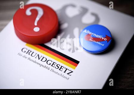 AFD-Parteiabzeichen und Fragezeichen zur deutschen Verfassung, symbolisches Foto zur AfD-Verbotsdebatte, Parteianstecker der AfD und Fragezeichen auf dem Stockfoto