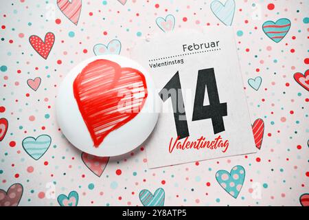 FOTOMONTAGE, Kalenderseite vom 14. Februar und Herz, symbolisches Foto Valentinstag, FOTOMONTAGE, Kalenderblatt vom 14. Februar. Februar und Herz, Symbol Stockfoto