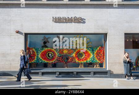 New Bond Street, London, Großbritannien. Oktober 2024. Sonniger Morgen in Londons bester Luxus-Einkaufsstraße nach mehreren Tagen des Niesels und des grauen Himmels. Hermes Ladenfenster hat ein herbstliches Farbmotiv. Quelle: Malcolm Park/Alamy Live News Stockfoto