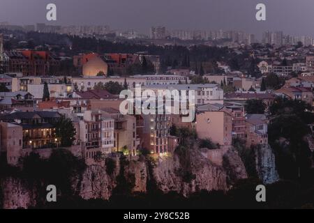 Stadtübersicht zur blauen Stunde in Tiflis, 14. September 2024. Am 26. Oktober 2024 wird das parlament in Georgien gewählt. Die Wahlen werden als wichtiger Wegweiser für das Land hinsichtlich seiner Ausrichtung auf Russland oder auf die Europäische Union angesehen. Gewalttätige Proteste gegen die derzeitige Regierungspartei Georgian Dream sorgten im Frühjahr 2023 und Frühjahr 2024 für internationalen Aufruhr, nachdem das umstrittene "Agent Law" umgesetzt wurde, das Parallelen zum 2012 in Russland verabschiedeten Gesetz hat und die Aktivitäten ausländischer Nichtregierungsorganisationen stark einschränkt. Stockfoto