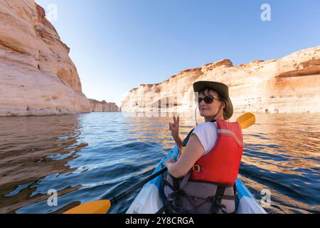 Zurück von jungen Mädchen gerne Kajak auf dem Lake Powell mit Paddel und Kajak und Schwimmweste auf Antelope Slot Canyon in Arizona im Sommer Stockfoto