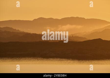 Stimmungsvolle Landschaftsszene bei Sonnenaufgang, Landschaft in der Dämmerung mit weichem Nebel, Herbst, Bergen, Nordsee, Norwegen, Europa Stockfoto