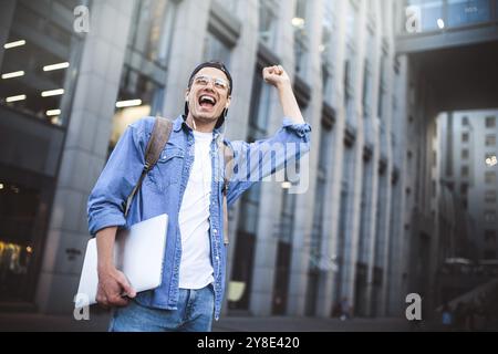 Man Sitzt Und Hört Musik-Kopfhörer-Konzept. Fröhlicher junger Kerl, der die Musik hört Stockfoto