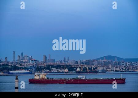 Istanbul. Türkiye. Ein großes Frachtschiff fährt durch den Bosporus mit den modernen Stadtteilen des asiatischen Kontinents im Hintergrund Stockfoto