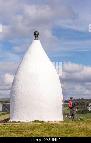 Wanderer und Rucksacktouristen in White Nancy, einem von Menschenhand geschaffenen Wahrzeichen auf dem Gritstone Trail auf der Spitze des Kerridge Hill mit Blick auf Bollington, Cheshire Stockfoto