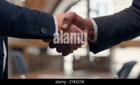 Nahaufnahme Männer Hände schütteln Handschütteln Büroverhandlungen Kandidat einstellen zwei nicht erkennbare Männer Geschäftstreffen Geschäftsleute multirassische Partner Stockfoto