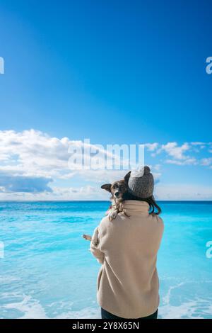 Frau mit Hund am Strand von Porto Katsiki mit türkisfarbenem Wasser Stockfoto