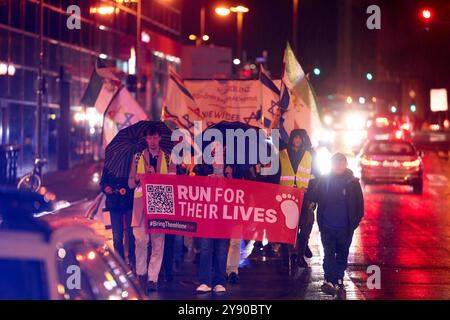 Koblenz, Deutschland. Oktober 2024. Teilnehmer einer Demonstration gegen Antisemitismus gehen hinter ein Banner mit der Aufschrift "Lauf um ihr Leben" am Jahrestag des Angriffs der Hamas auf Israel. Quelle: Thomas Frey/dpa/Alamy Live News Stockfoto