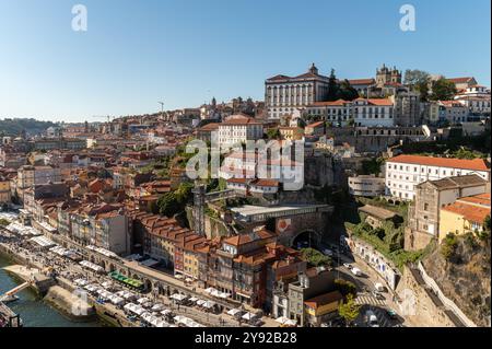 Porto, Portugal - 12. September 2024 : die pulsierenden Gebäude von Porto überblicken den Fluss Douro unter klarem blauem Himmel. Stockfoto