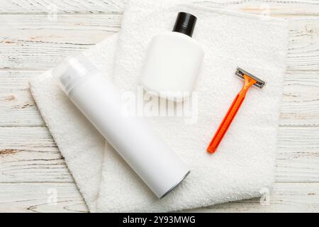 Rasierer-Set. Schermaschine, Handtuch, Lotion und Rasierschaum auf farbigem Hintergrund. Herren Bad Accessoires Draufsicht. Stockfoto