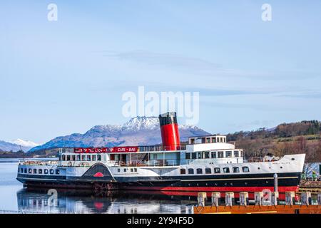 Der Raddampfer Maid of the Loch spiegelt sich in den stillen Gewässern des Loch Lomond mit Schnee auf dem Gipfel des Ben Lomond an einem frischen Wintertag. Stockfoto