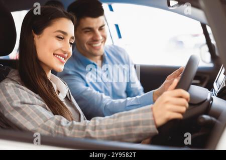 Junge Ehepartner, Die Sich Für Ein Auto Im Händlershop Entscheiden Stockfoto