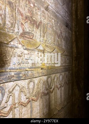 Edfu, Ägypten; 17. Januar 2024: Erkunden Sie das reiche Erbe des alten Ägypten, während Sie die Hieroglyphen und Kartuschen, die die Wände zieren, untersuchen. Stockfoto