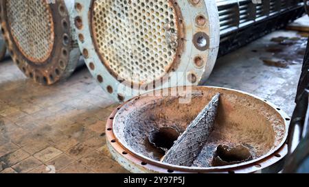 Korrosion, Raffinerie-Wärmetauscher Kühlrohre mit Flanschsystem. Reihe von industriellen Wärmetauschern oder Kesseln mit Abdeckungen rostigen Rohrblech oder Stockfoto