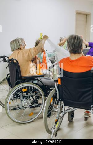 Gruppe älterer Menschen in einem Pflegeheim, die Zeit mit ihrem freundlichen Hund verbringen. Hochwertige Fotos Stockfoto