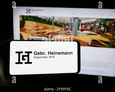 In dieser Abbildung zeigt ein Smartphone mit dem Logo des deutschen Reisehandelsunternehmens Gebr. Heinemann SE Co. KG vor der Website. Stockfoto