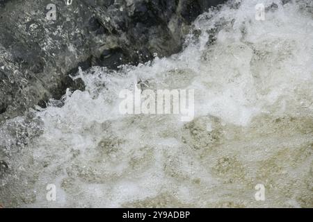 Eine detaillierte Nahansicht eines Flusses mit Schaumstoff, der aus ihm sprudelt Stockfoto