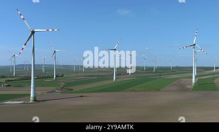 Luftaufnahme von Windturbinen und landwirtschaftlichen Feldern. Windmühlen Turbinen erzeugen Strom, grüne Energie Stockfoto