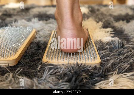 Nahaufnahme von Frauenfüßen auf Sadhu-Brettern. Alternativmedizin und Yoga-Konzept. Stockfoto