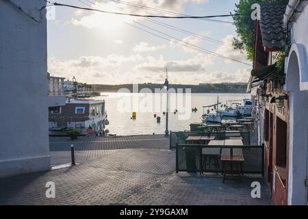 Blick auf den Hafen von Cales Fonts am Morgen mit kleinen Booten und Restaurants in der Stadt Mahon und es Castell auf der Insel Menorca auf den balearen Stockfoto