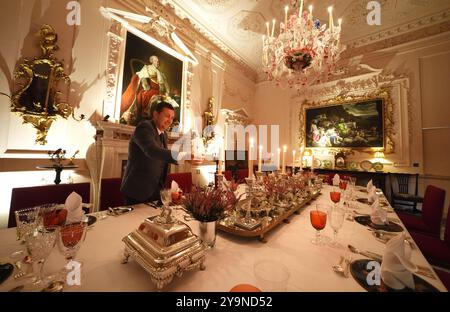 Evan Samson, der das Front-of-House-Team im Dumfries House leitet, zündet Kerzen an, während er dem Pink Dining Room, dem Lieblingszimmer des Königs im Dumfries House in Cumnock, Ayrshire, den letzten Schliff verleiht, wo Mitglieder der Öffentlichkeit die Möglichkeit erhalten, ein fest aus dem 18. Jahrhundert zu genießen, als Teil eines neuen maßgeschneiderten Dining Experience, das von der King's Foundation Charity geleitet wird. Bilddatum: Donnerstag, 10. Oktober 2024. Stockfoto