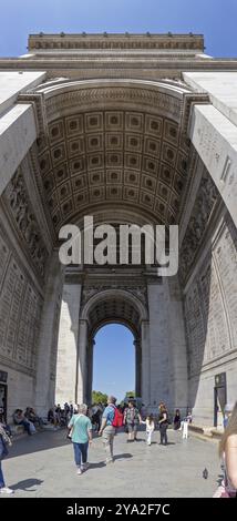 Touristen spazieren durch den beeindruckenden Arc de Triomphe in Paris, Paris Stockfoto