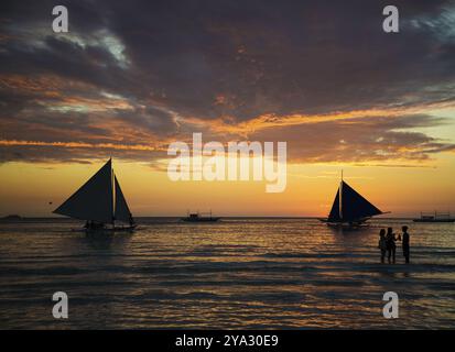 Sonnenuntergang und touristische Segelboote am tropischen weißen Strand in boracay philippinen Stockfoto