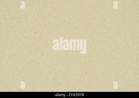 Abstrakte Hintergrundtextur von weißem Sand an Einem tropischen Strand Stockfoto