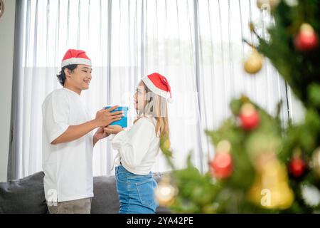 asiatischer Mann gibt weihnachtsgeschenk Freundin Stockfoto