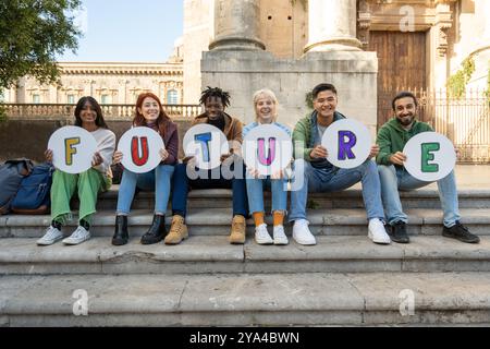 Fröhliche, vielfältige Gruppe von Studenten mit handgeschriebenen „ZUKUNFTSSCHILDERN“ auf dem Universitätscampus. Multikulturelle junge Menschen, die Hoffnung, Bildung, A repräsentieren Stockfoto